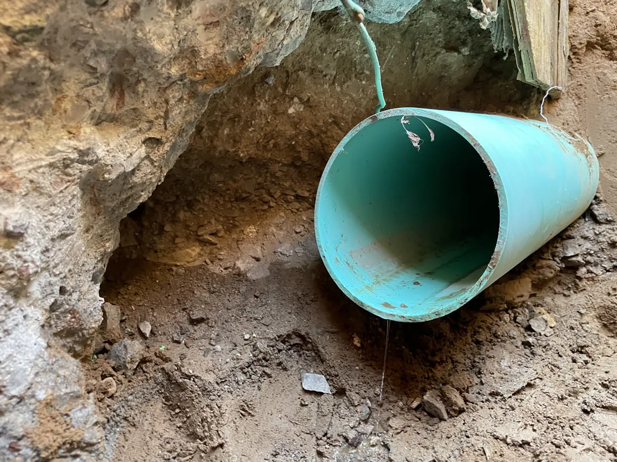 Sewer pipe exposed in the trench